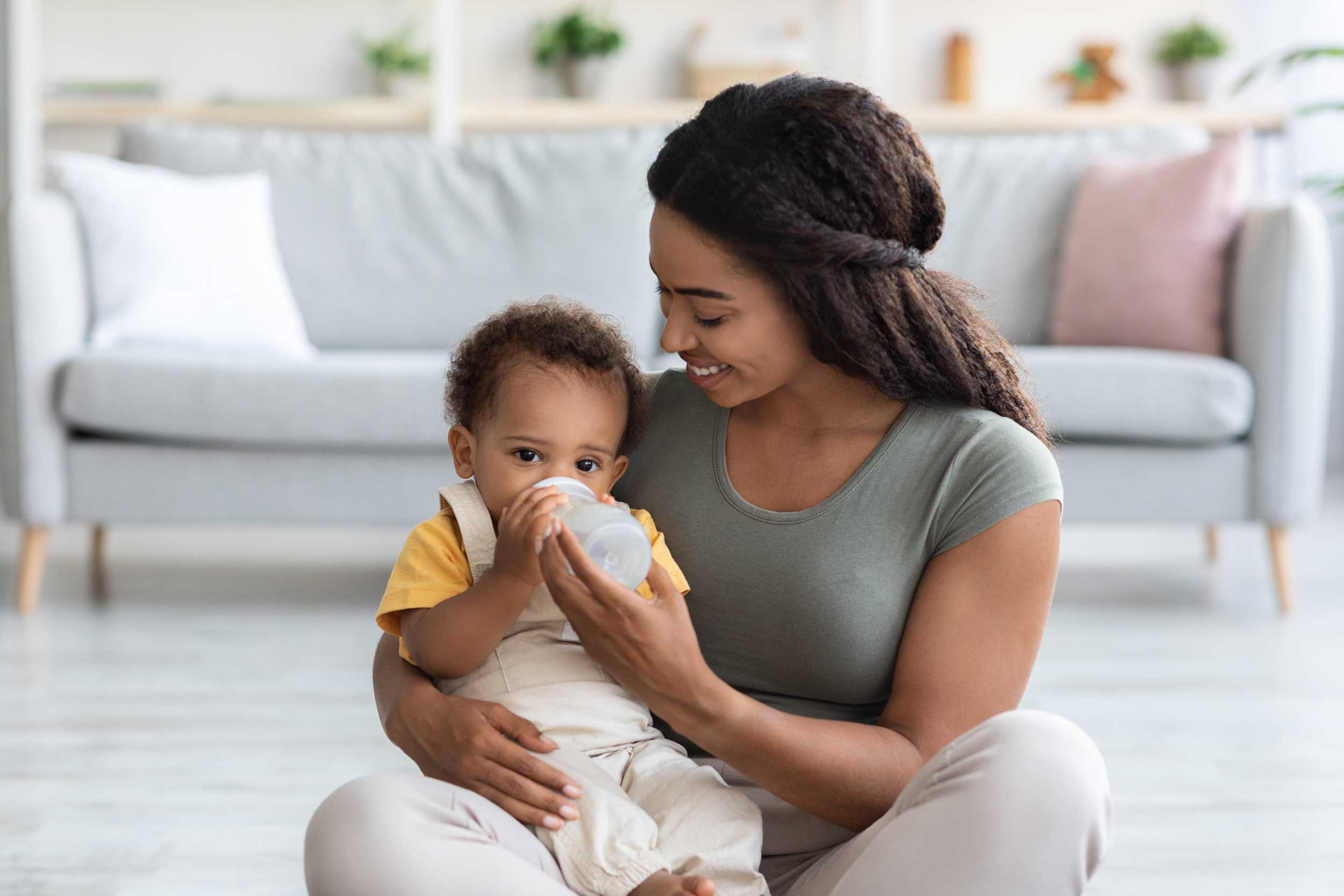 baby-care-loving-black-mom-giving-water-bottle-to-2022-02-03-02-02-37-utc.jpg